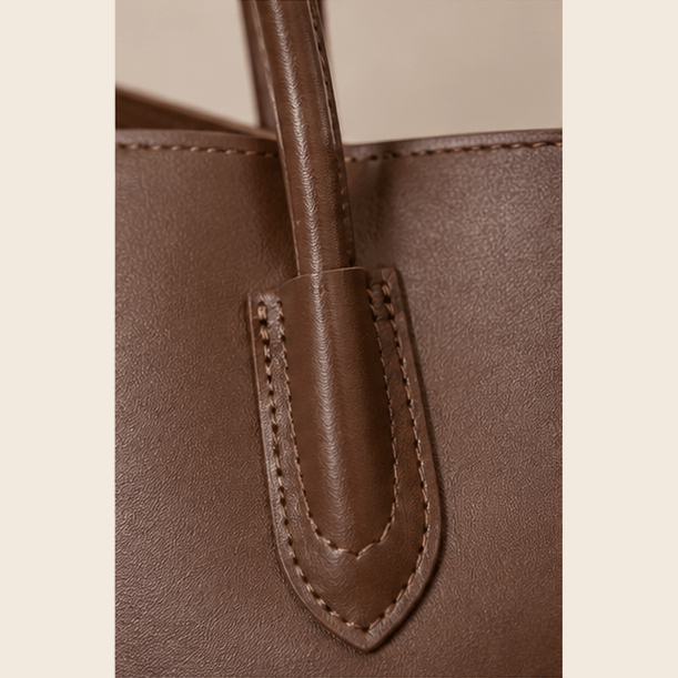 Close-up of Aveline leather handle stitching and gold-tone hardware