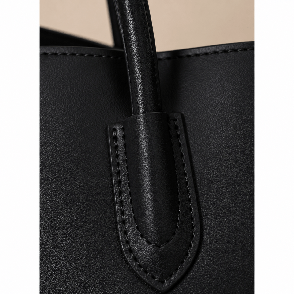 Close-up of the handle and stitching on the Aveline Black Leather Tote Bag