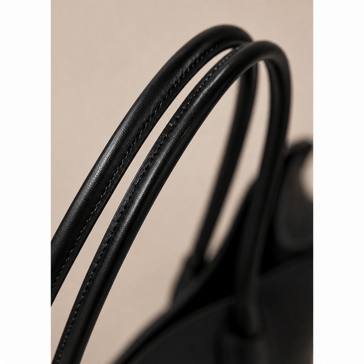 Close-up of the handles on the Aveline Black Leather Tote Bag